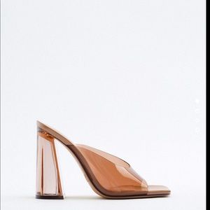 Front vinyl strap with squared vamp and transparent heels. Only worn once.